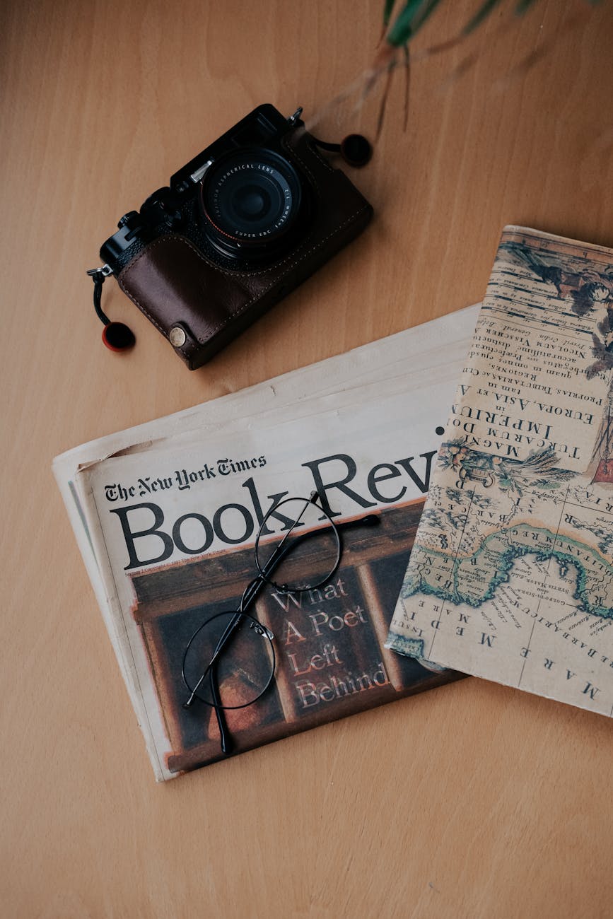 camera and glasses on the newspaper